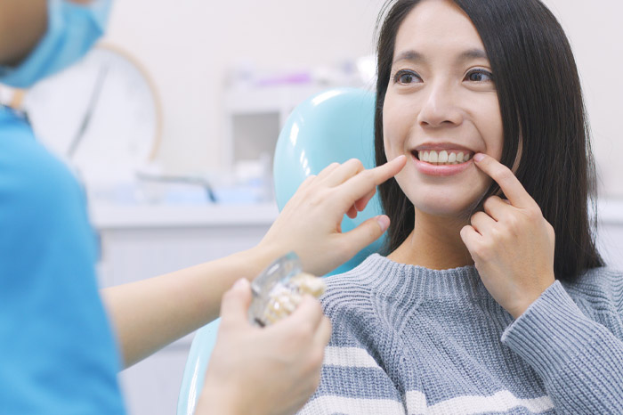 Dental patient receiving consultation regarding tooth whitening, like the services provided by AKJ Dentistry in Lubbock.